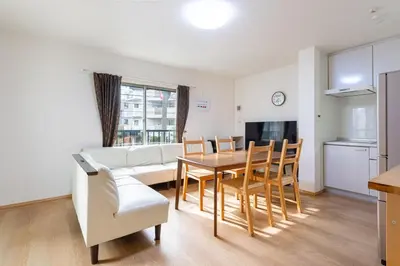 a living room with a table and a couch at \u6771\u4e2d\u91ce in Tokyo