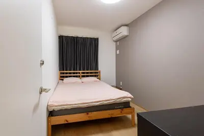 a small bedroom with a bed in a room at \u6771\u4e2d\u91ce in Tokyo