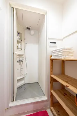a walk in shower in a bathroom with a mirror at \u6771\u4e2d\u91ce in Tokyo