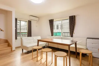 a living room with a table and chairs at \u6771\u4e2d\u91ce in Tokyo
