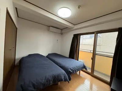 a bedroom with a bed and a large window at Tokyo Stay Ikebukuro #303 in Tokyo