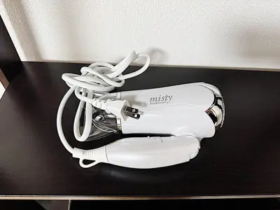 a white hair dryer sitting on a black table at Tokyo Stay Ikebukuro #303 in Tokyo