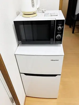 a microwave sitting on top of a white cabinet at Tokyo Stay Ikebukuro #303 in Tokyo
