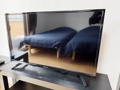 a mirror on top of a desk with a bed at Tokyo Stay Ikebukuro #303 in Tokyo