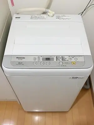 a white washing machine sitting on a floor at Tokyo Stay Ikebukuro #303 in Tokyo