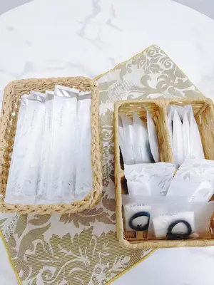 two baskets filled with white packets on a table at \u9ad8\u8f2a\u30fc703 in Tokyo
