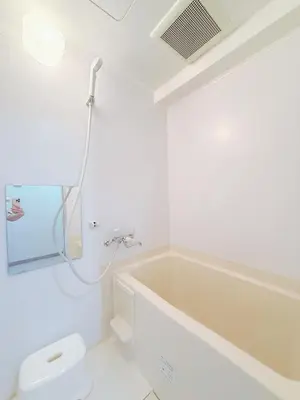 a white bathroom with a tub and a toilet at \u9ad8\u8f2a\u30fc703 in Tokyo