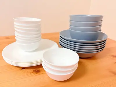 a stack of white plates and bowls on a table at \u6c60\u888b\u672c\u753a301 in Tokyo