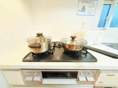 two pots on top of a stove in a kitchen at \u6c60\u888b\u672c\u753a301 in Tokyo