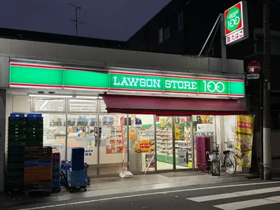 a grocery store with a green sign on the front at \u6c60\u888b\u672c\u753a301 in Tokyo