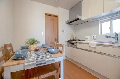 a kitchen with a table with bowls on it at \u6c60\u888b\u672c\u753a301 in Tokyo