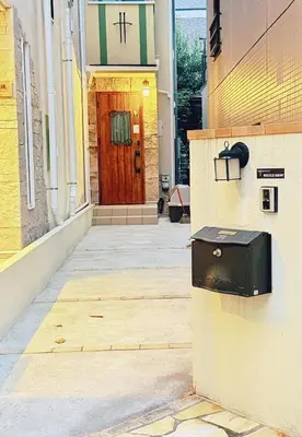 a front door of a church with a mailbox at \u6c60\u888b\u672c\u753a301 in Tokyo