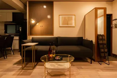 a living room with a couch and a table at #32 -\u670d\u90e8\u30d3\u30eb\u6771\u6c60\u888b- Condo in Tokyo