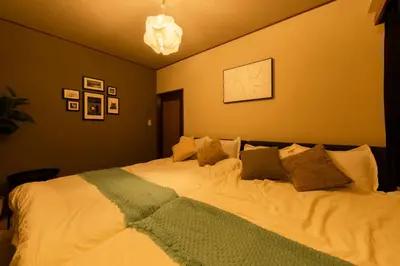 a bedroom with a large white bed with pillows at #32 -\u670d\u90e8\u30d3\u30eb\u6771\u6c60\u888b- Condo in Tokyo