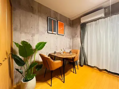 a dining room with a table and a potted plant at Amika First 202 AF22 in Tokyo