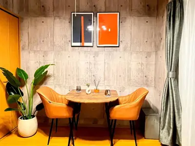 a dining room with a wooden table and chairs at Amika First 202 AF22 in Tokyo