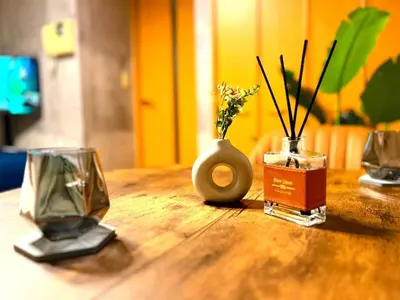 a wooden table with two vases with flowers on it at Amika First 202 AF22 in Tokyo