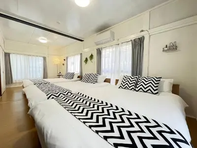 two large white beds in a room with windows at Higashi tateishi Kodate HTI1 in Tokyo