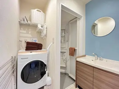 a bathroom with a washing machine and a sink at Higashi tateishi Kodate HTI1 in Tokyo