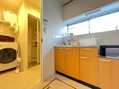 a kitchen with orange cabinets and a microwave at Higashi tateishi Kodate HTI1 in Tokyo
