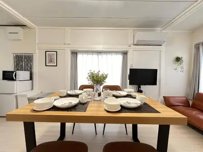 a table in a living room with a dining room at Higashi tateishi Kodate HTI1 in Tokyo