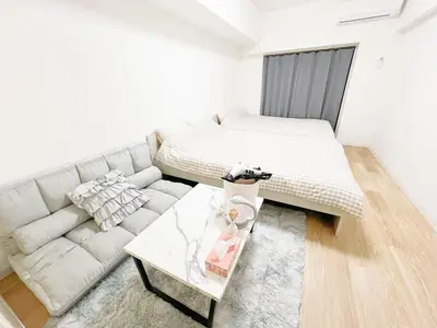 a living room with a couch and a bed at Ikebukuro home 18 in Tokyo