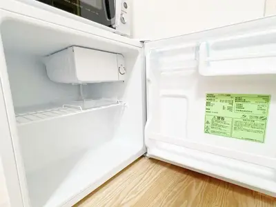 an empty refrigerator with its door open in a kitchen at Ikebukuro home 18 in Tokyo