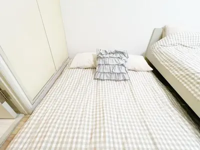 a small room with two beds in a room at Ikebukuro home 18 in Tokyo