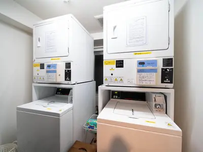 three machines are stacked on top of each other in a room at Super Hotel Shinbashi-Karasumoriguchi in Tokyo