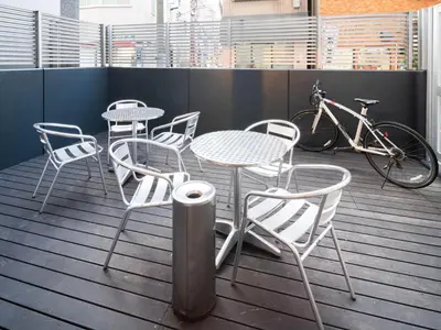 a patio with a table and chairs and a bike at Super Hotel Shinbashi-Karasumoriguchi in Tokyo