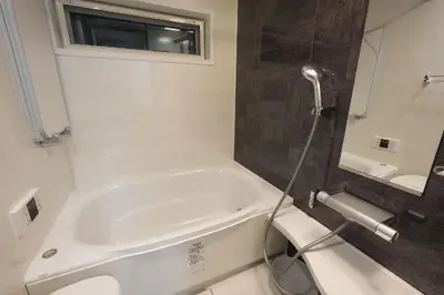 a bathroom with a white tub and a sink at 100 INN Suite in Tokyo