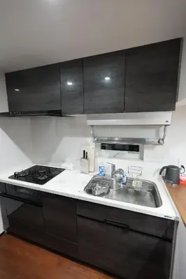 a kitchen with a sink and a stove at 100 INN Suite in Tokyo