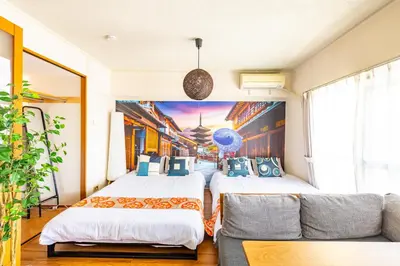 two beds in a room with a couch at SakuraFlat in Tokyo