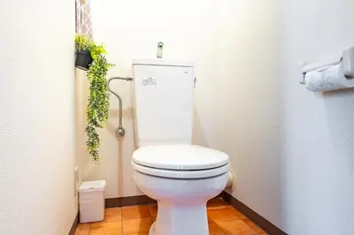 a bathroom with a white toilet in a stall at SakuraFlat in Tokyo
