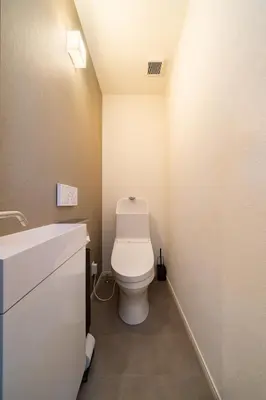 a bathroom with a white toilet and a sink at Vacation house rental Matsu kaze tei Tokyo in Tokyo