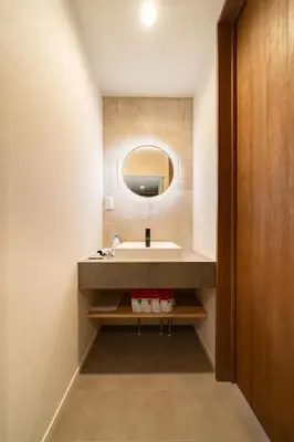 a bathroom with a sink and a mirror at Vacation house rental Matsu kaze tei Tokyo in Tokyo