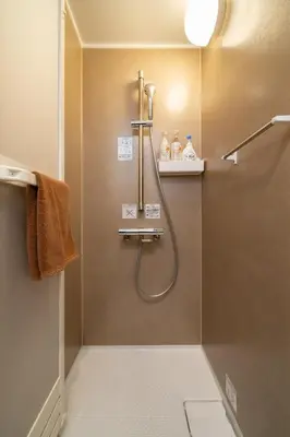 a bathroom with a shower with a glass door at Vacation house rental Matsu kaze tei Tokyo in Tokyo