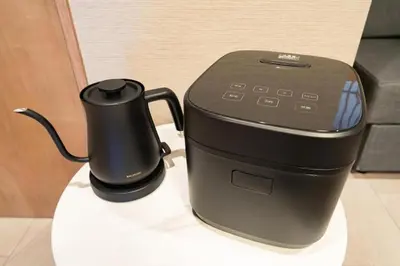 a black coffee maker sitting on a table at Vacation house rental Matsu kaze tei Tokyo in Tokyo