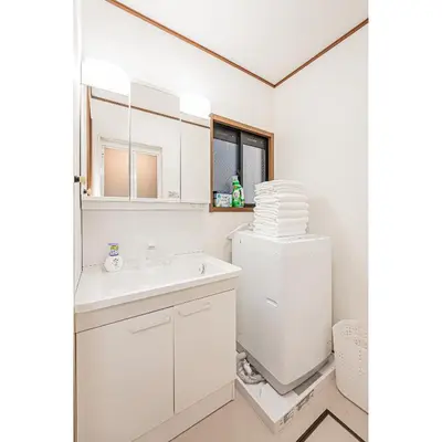 a white bathroom with a sink and a refrigerator at Tokyo Stay House Hirai in Tokyo