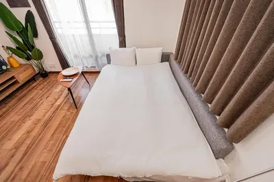 a large bed in a room with a window at Tokyo Stay House Hirai in Tokyo