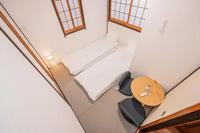 an overhead view of a small room with a bed and a table at Tokyo Stay House Hirai in Tokyo