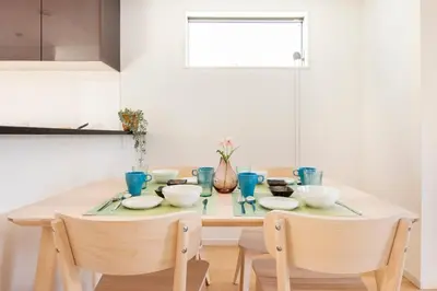 a dining room table with blue glasses on it at Cozy Stay Kanamecho in Tokyo