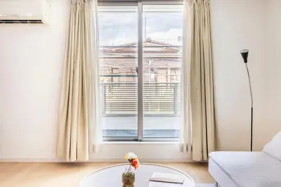a living room with a window and a white couch at Cozy Stay Kanamecho in Tokyo