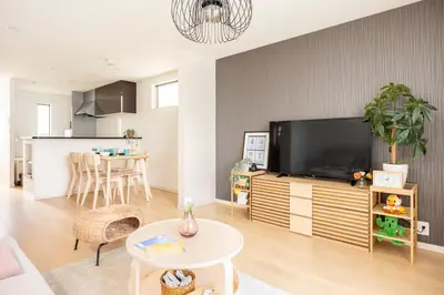a living room with a flat screen tv and a table at Cozy Stay Kanamecho in Tokyo