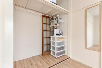 a walk in closet with a door and a mirror at tkm\u5317\u5c0f\u5ca91\u4e01\u76ee103 in Tokyo
