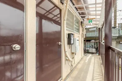 an empty hallway with a door in a building at tkm\u5317\u5c0f\u5ca91\u4e01\u76ee201 in Tokyo