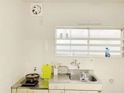 a white kitchen with a sink and a window at tkm\u5317\u5c0f\u5ca91\u4e01\u76ee201 in Tokyo