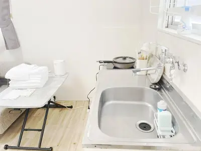 a kitchen with a sink and a counter top at tkm\u5317\u5c0f\u5ca91\u4e01\u76ee201 in Tokyo