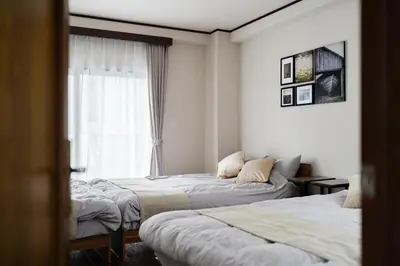 a hotel room with two beds and a window at Apartment hotel 3 minutes walk from JR Asagaya station Ideal base for exploring Tokyo HOTEL CtrlD ASAGAYA in Tokyo