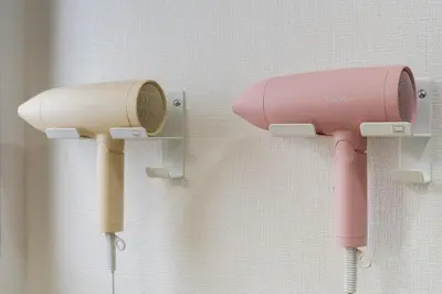 a pink hair dryer hanging on a wall at Apartment hotel 3 minutes walk from JR Asagaya station Ideal base for exploring Tokyo HOTEL CtrlD ASAGAYA in Tokyo